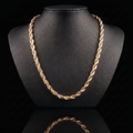 10k gold hollow diamond-cut rope chain draped on a black jewelry bust, front view