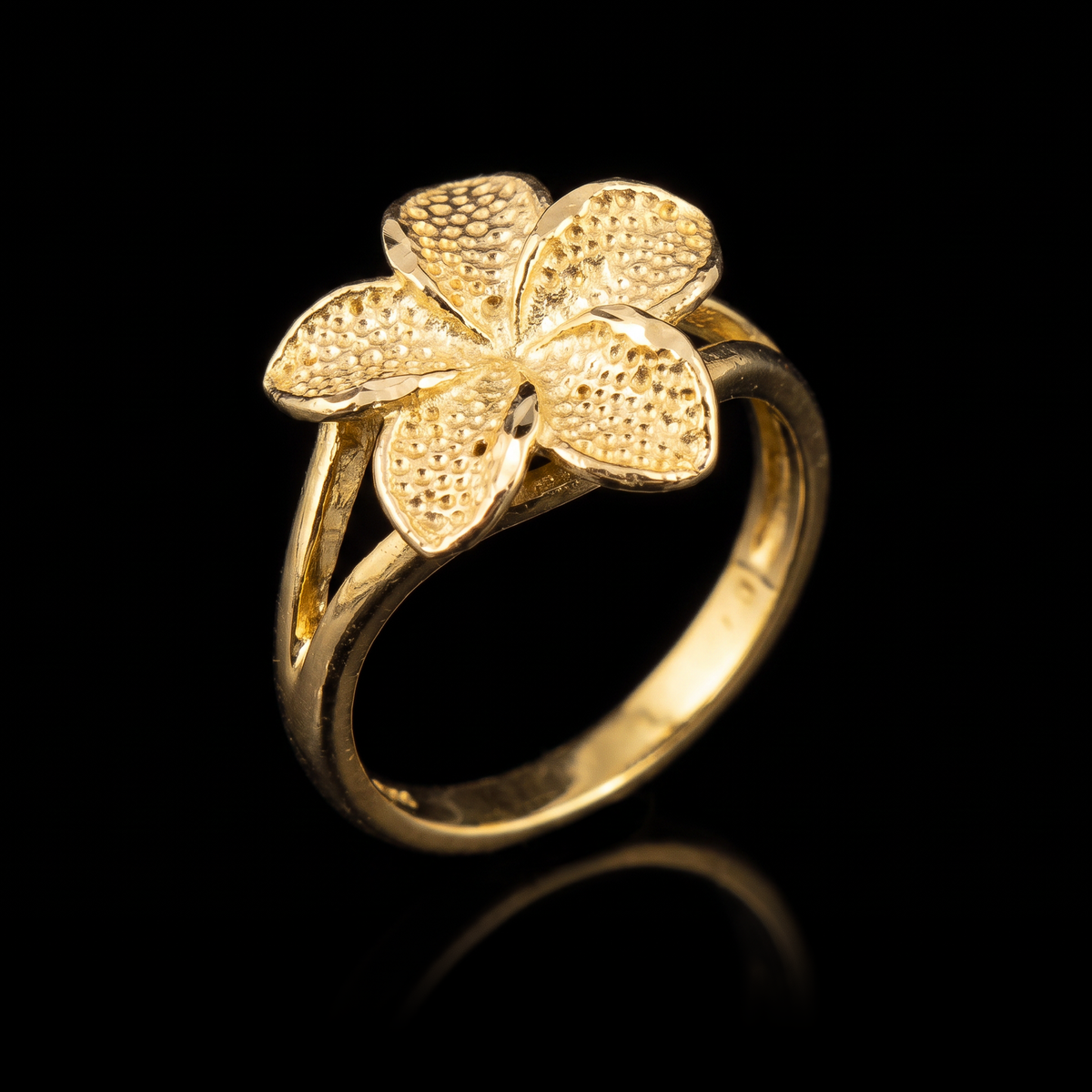 10k gold hibiscus flower ring at a 45-degree angle on black