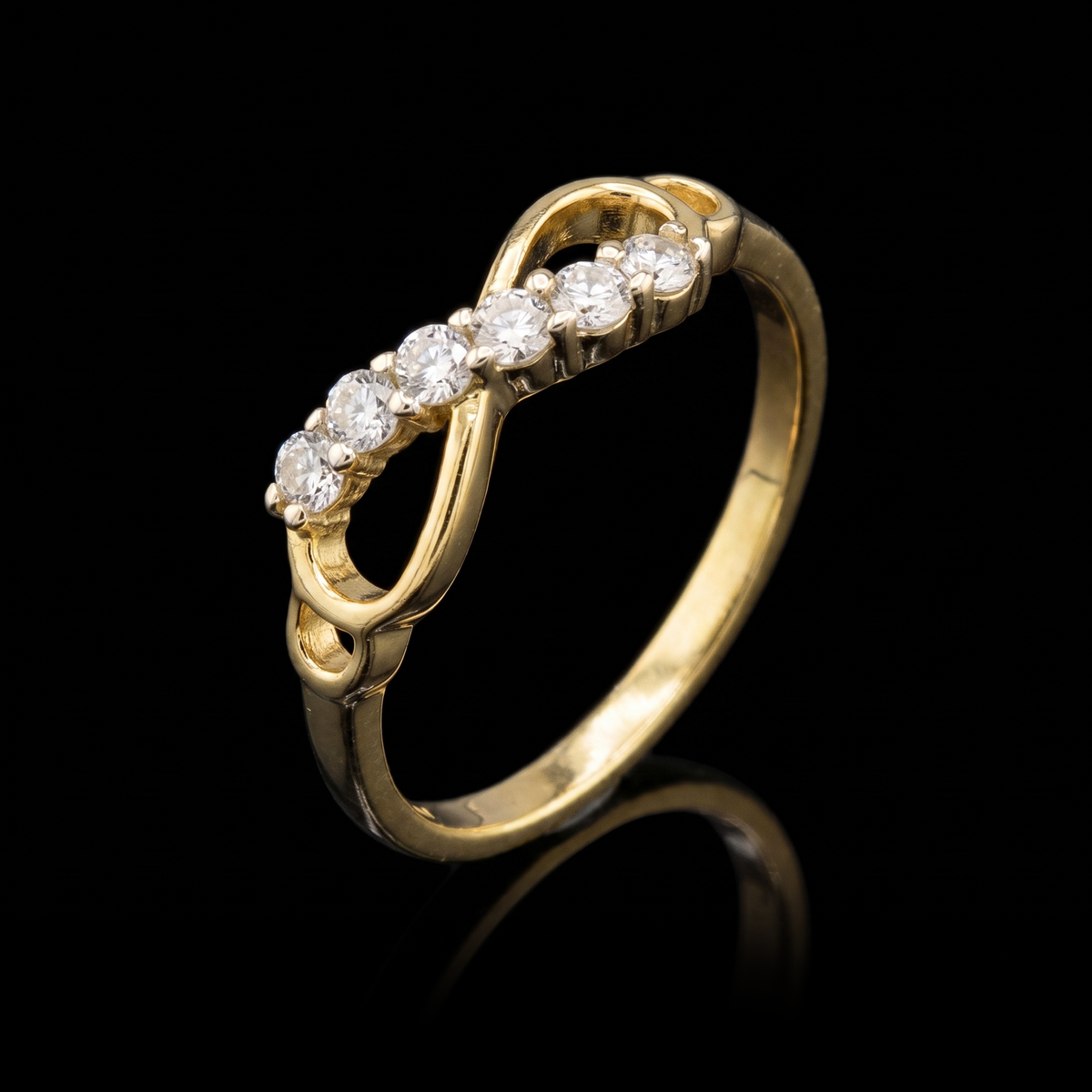 10k gold CZ infinity ring at a 45-degree angle on black