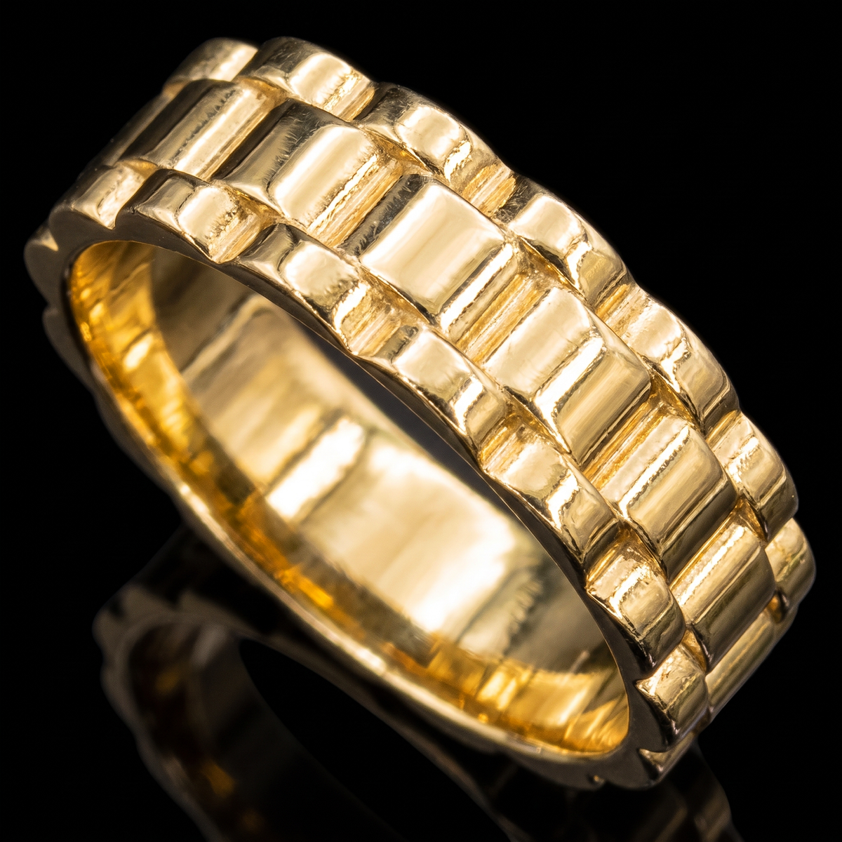 10k gold Rolex band ring 6mm Rolex link band detail macro on black