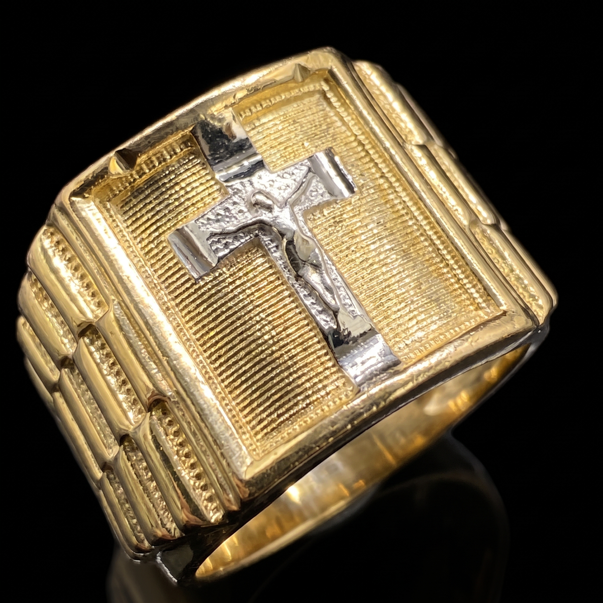 10k gold two-tone Rolex crucifix ring 13mm white gold crucifix face detail macro on black