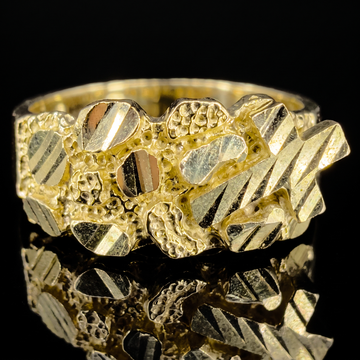 10k gold cross nugget ring 9.5mm cross nugget face detail macro on black