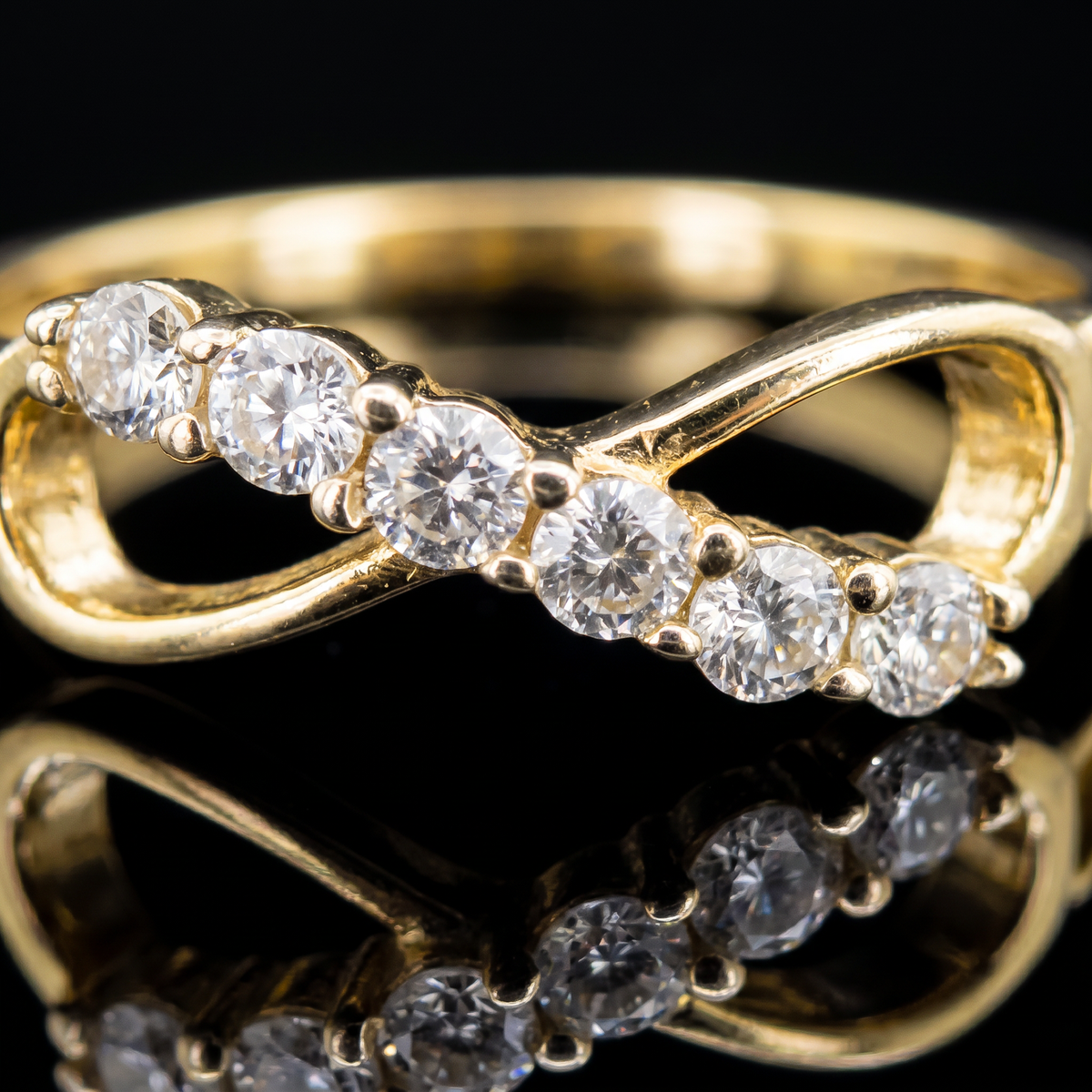 10k gold CZ infinity ring infinity detail macro on black