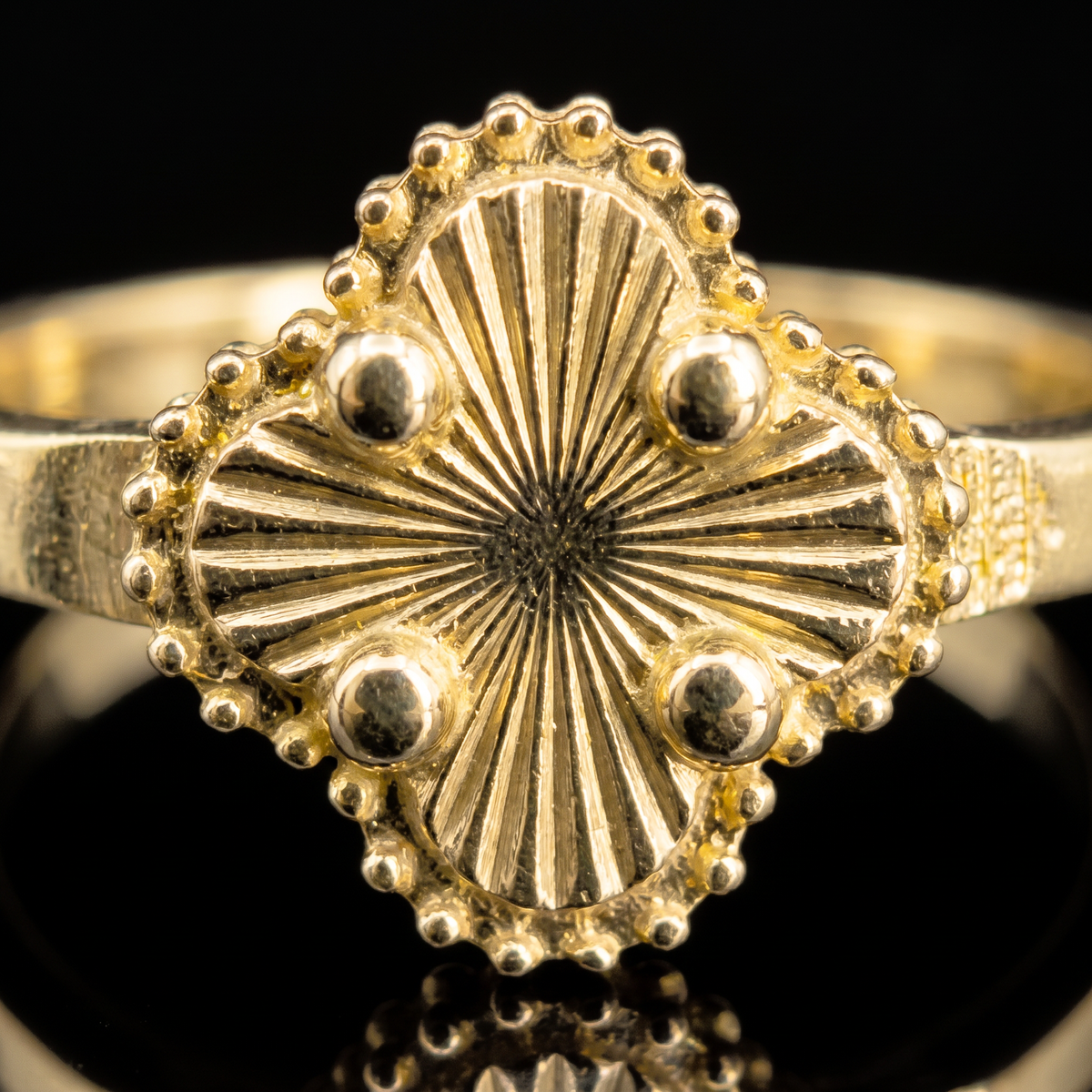 10k gold clover ring clover detail macro on black