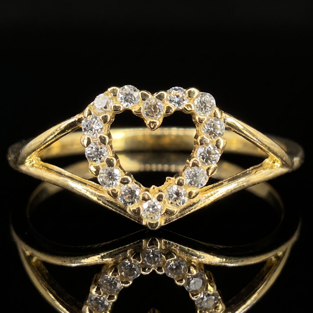 10k gold CZ open heart ring open heart detail macro on black