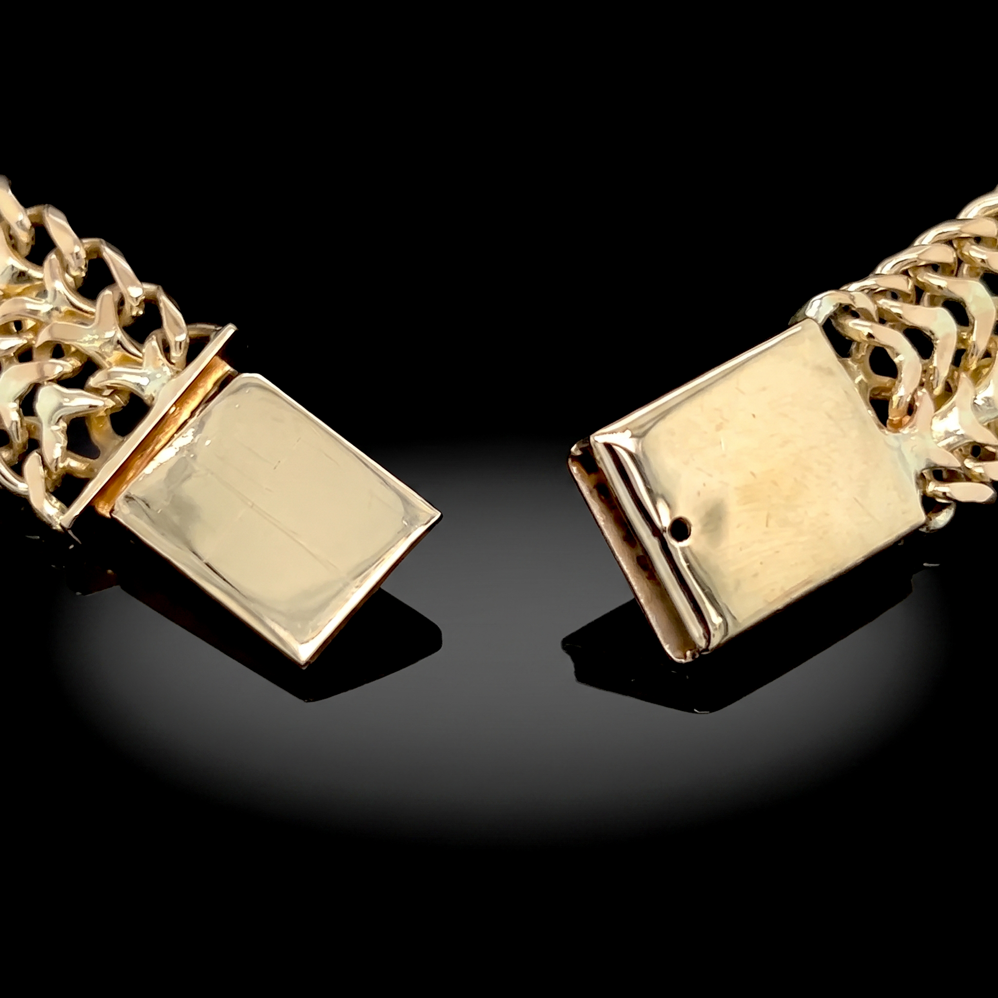 Flat slide clasp of the 10k gold petatillo ID bracelet, open showing the tongue and sleeve