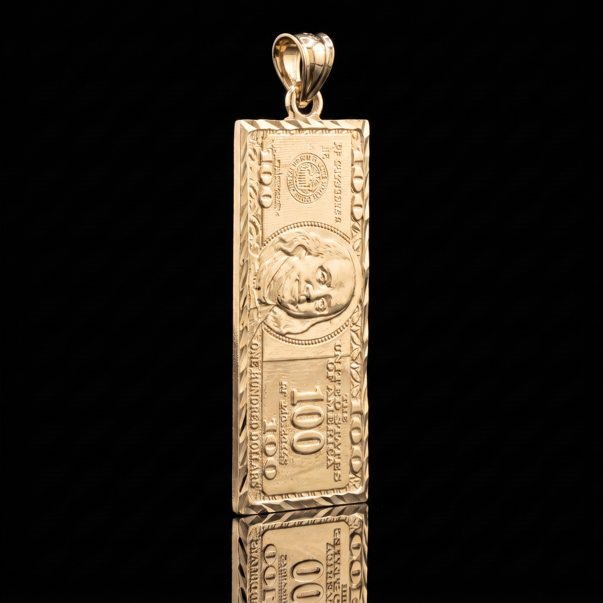 10k gold $100 bill pendant, angled on black